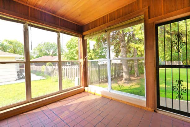 A 1950s mid-century modern bungalow style house in the mid-west of United States. The real estate featuring a screen-in porch.